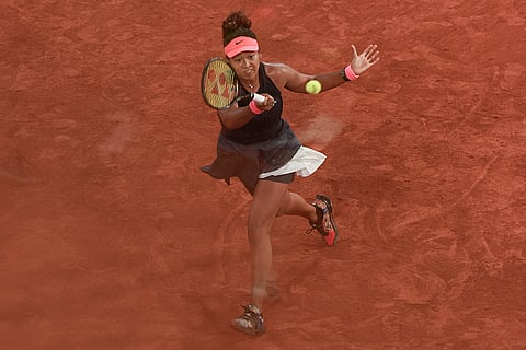 Naomi Osaka plays a shot against Iga Swiatek